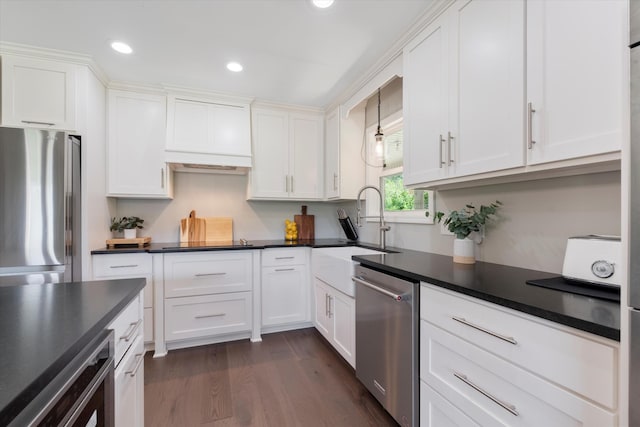 593 Gaulden Hollow Rd, Lafayette, TN 37083 - kitchen with stainless steel appliances, white cabinets, a sink, dark countertops, and dark wood-style floors