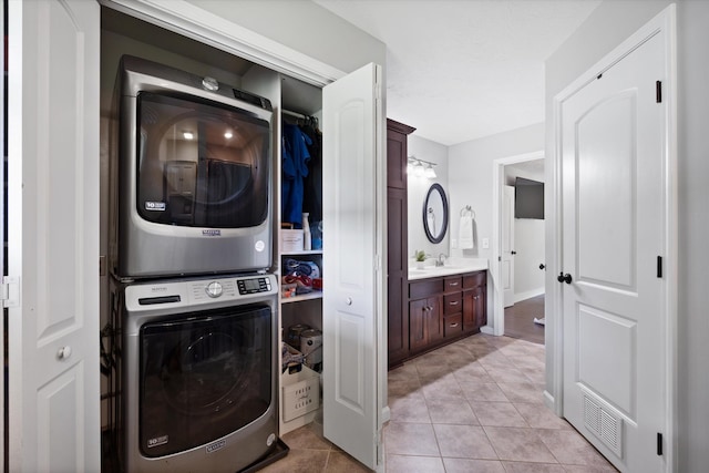 593 Gaulden Hollow Rd, Lafayette, TN 37083 - clothes washing area with stacked washing machine and dryer and light tile patterned flooring