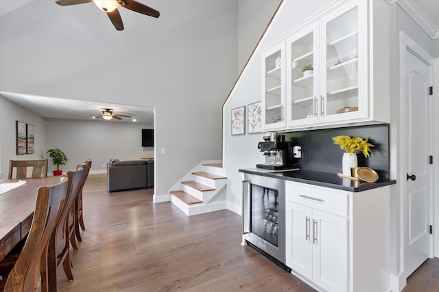 593 Gaulden Hollow Rd, Lafayette, TN 37083 - bar featuring ceiling fan, beverage cooler, stairway, wood finished floors, and baseboards