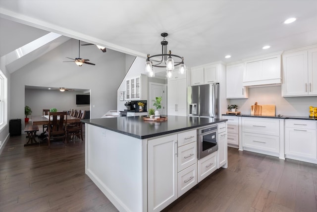 593 Gaulden Hollow Rd, Lafayette, TN 37083 - kitchen featuring stainless steel fridge with ice dispenser, dark countertops, white cabinetry, recessed lighting, and vaulted ceiling