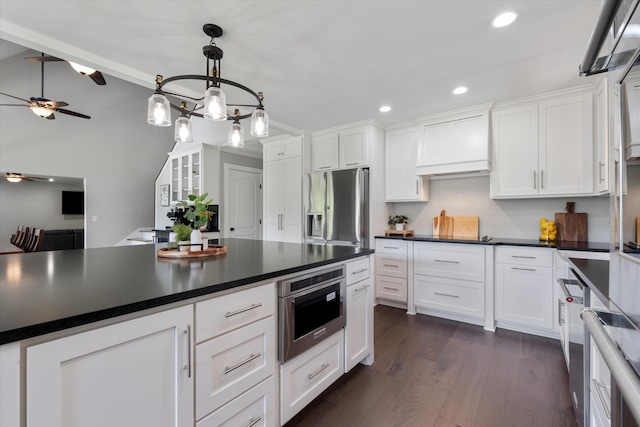 593 Gaulden Hollow Rd, Lafayette, TN 37083 - kitchen with stainless steel fridge with ice dispenser, dark countertops, white cabinetry, ceiling fan, and recessed lighting