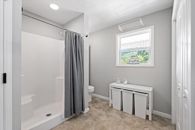 593 Gaulden Hollow Rd, Lafayette, TN 37083 - bathroom with a stall shower, toilet, and baseboards