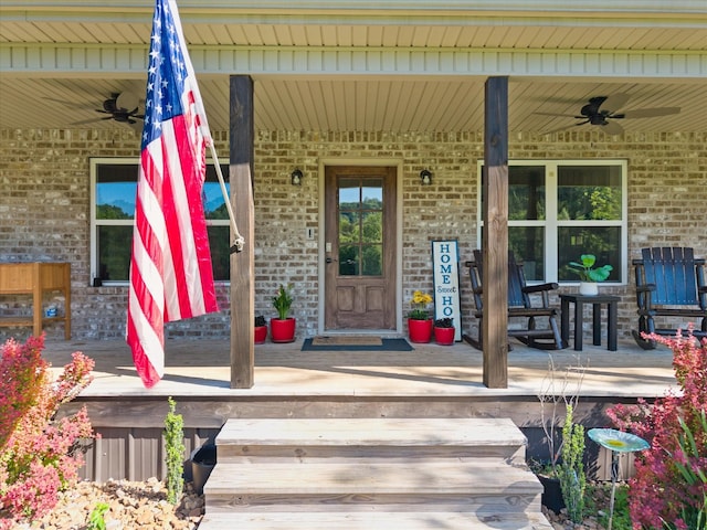 593 Gaulden Hollow Rd, Lafayette, TN 37083 - view of exterior entry featuring ceiling fan, brick siding, and a porch