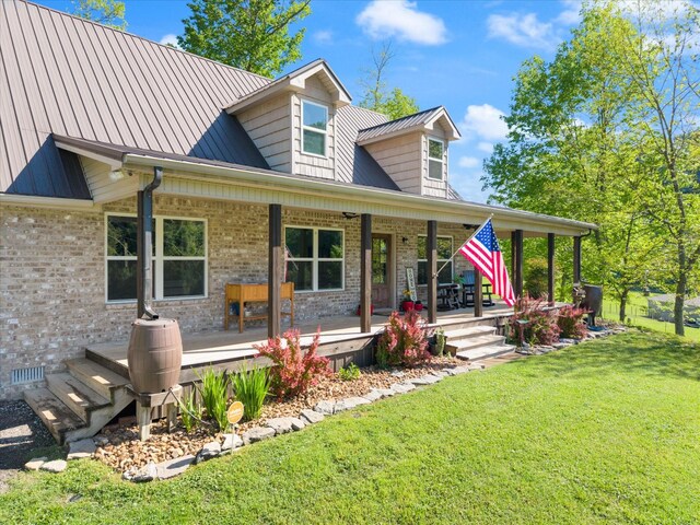 593 Gaulden Hollow Rd, Lafayette, TN 37083 - view of front of home featuring brick siding, a front yard, covered porch, and metal roof