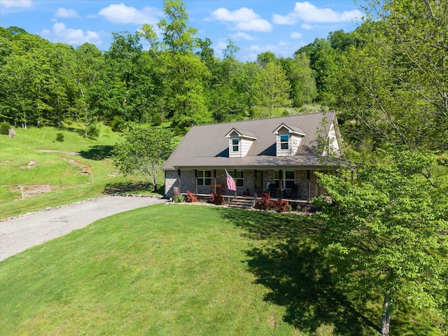 593 Gaulden Hollow Rd, Lafayette, TN 37083 - cape cod house with covered porch, a front yard, dirt driveway, a view of trees, and metal roof