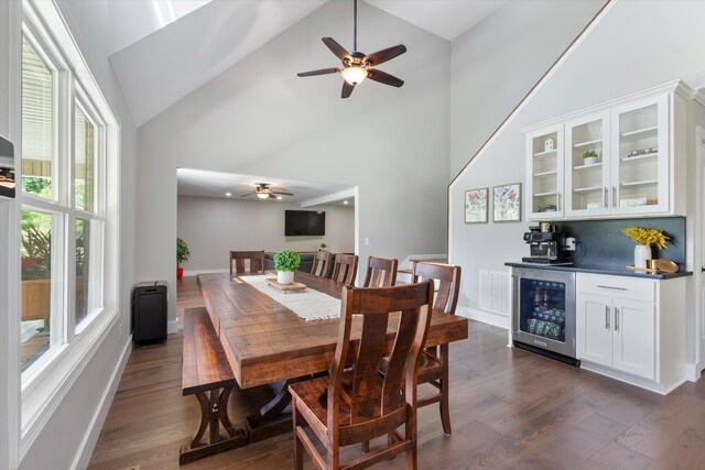 593 Gaulden Hollow Rd, Lafayette, TN 37083 - dining space with beverage cooler, high vaulted ceiling, bar, ceiling fan, and dark wood finished floors
