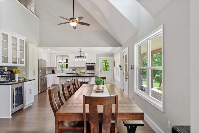 593 Gaulden Hollow Rd, Lafayette, TN 37083 - dining space featuring beverage cooler, high vaulted ceiling, dark wood-style floors, a chandelier, and a ceiling fan