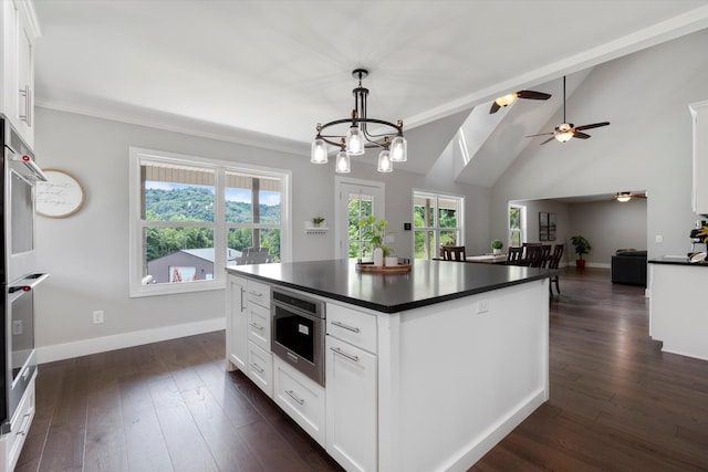593 Gaulden Hollow Rd, Lafayette, TN 37083 - kitchen featuring dark countertops, baseboards, white cabinets, dark wood finished floors, and lofted ceiling