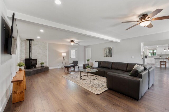 593 Gaulden Hollow Rd, Lafayette, TN 37083 - living room with ceiling fan, a wood stove, wood finished floors, recessed lighting, and beam ceiling