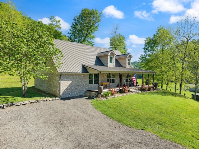 593 Gaulden Hollow Rd, Lafayette, TN 37083 - view of front of house featuring a porch, a front yard, metal roof, driveway, and brick siding