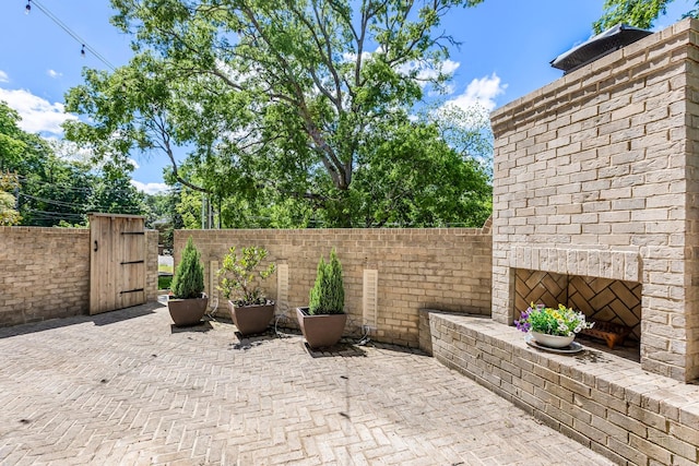 3692 Auburn Ln, Nashville, TN 37215 - view of patio featuring an outdoor brick fireplace, a gate, and fence