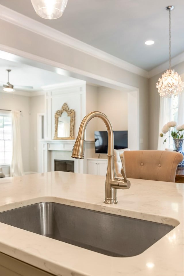 3692 Auburn Ln, Nashville, TN 37215 - kitchen view of light stone countertops, a sink, ornamental molding, hanging light fixtures, and recessed lighting