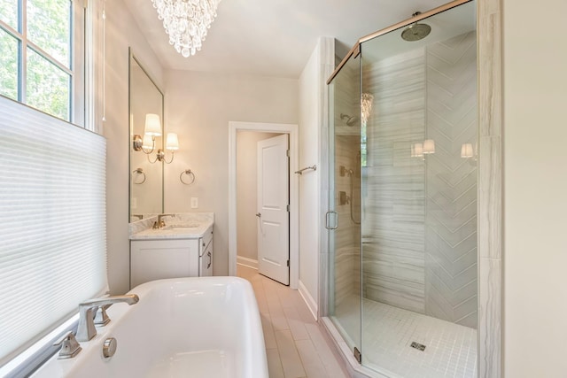 3692 Auburn Ln, Nashville, TN 37215 - bathroom featuring a stall shower, a chandelier, vanity, a tub to relax in, and baseboards