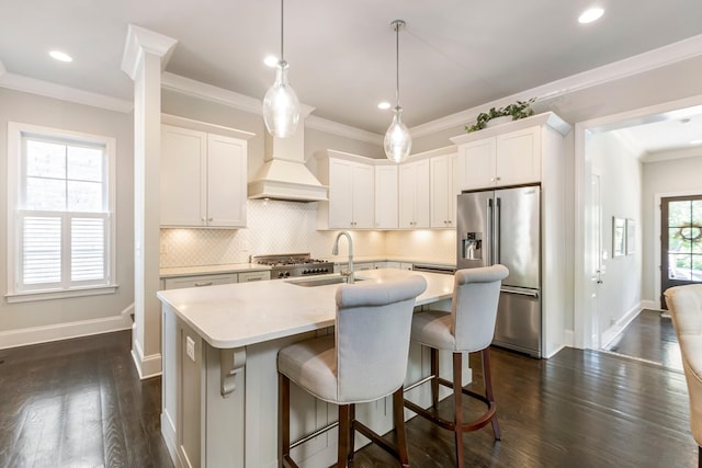 3692 Auburn Ln, Nashville, TN 37215 - kitchen with high end refrigerator, an island with sink, premium range hood, white cabinets, and ornamental molding