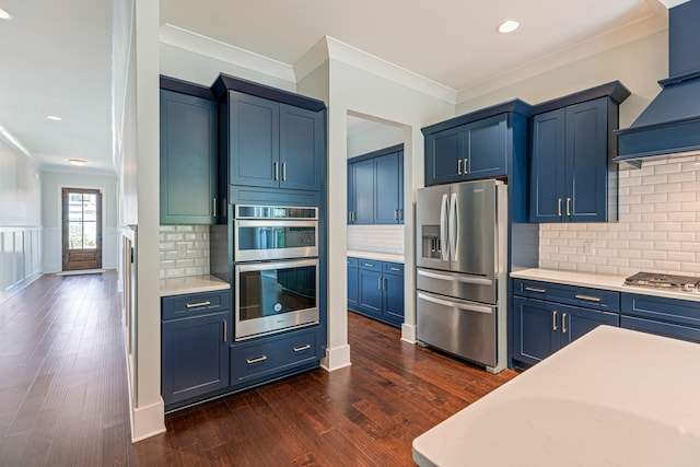 kitchen with stainless steel appliances, crown molding, blue cabinetry, light countertops, and decorative backsplash
