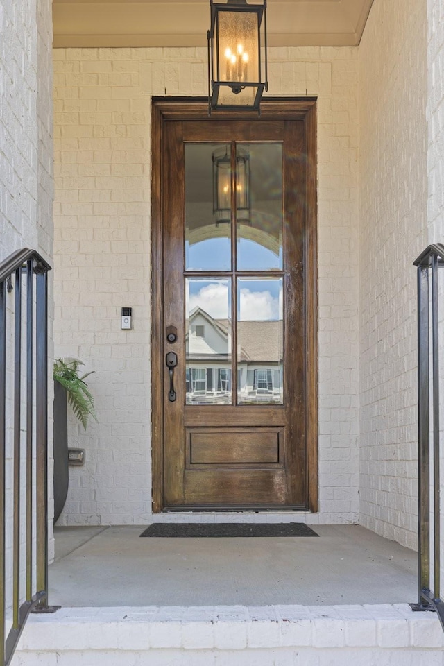 property entrance featuring brick siding