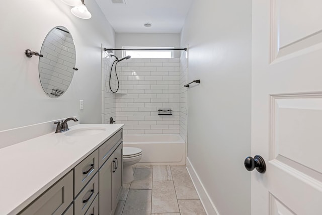 full bath featuring vanity, toilet, baseboards, and tub / shower combination