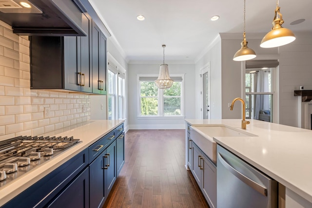 kitchen with a sink, stainless steel appliances, extractor fan, dark wood-type flooring, and light countertops