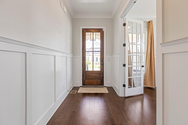entryway featuring a decorative wall, dark wood-type flooring, wainscoting, and ornamental molding