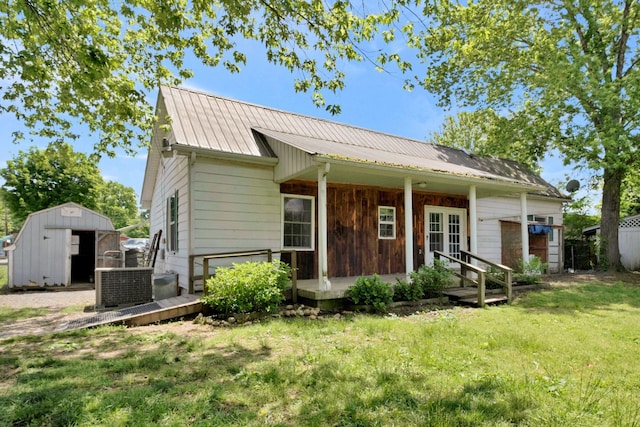 159 Clover St, Granville, TN 38564 - view of front of home featuring a storage unit, a front lawn, metal roof, central air condition unit, and an outdoor structure