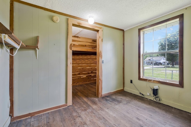 159 Clover St, Granville, TN 38564 - unfurnished bedroom with multiple windows, wood finished floors, a textured ceiling, ornamental molding, and baseboards