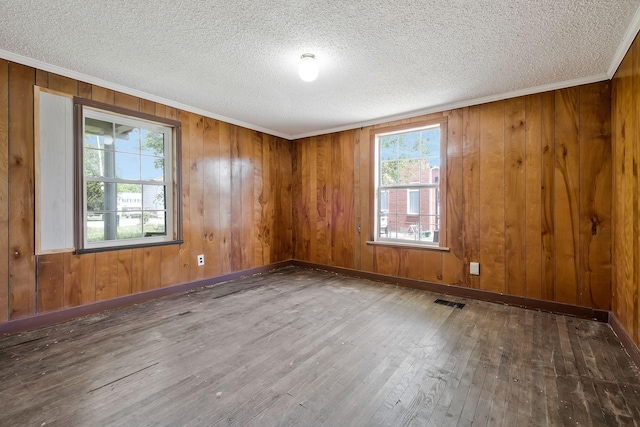 159 Clover St, Granville, TN 38564 - unfurnished room with hardwood / wood-style floors, a textured ceiling, ornamental molding, wood walls, and baseboards