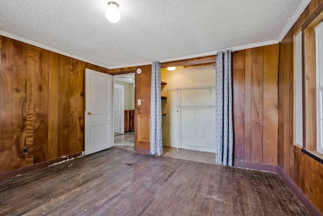 159 Clover St, Granville, TN 38564 - unfurnished bedroom featuring wood-type flooring, a textured ceiling, wooden walls, and ornamental molding