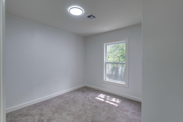 carpeted empty room with baseboards
