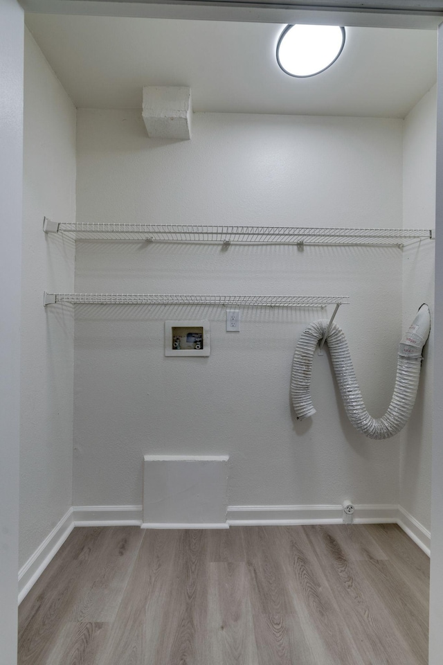 laundry area featuring wood finished floors, washer hookup, and baseboards