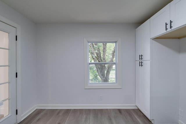 spare room with wood finished floors and baseboards