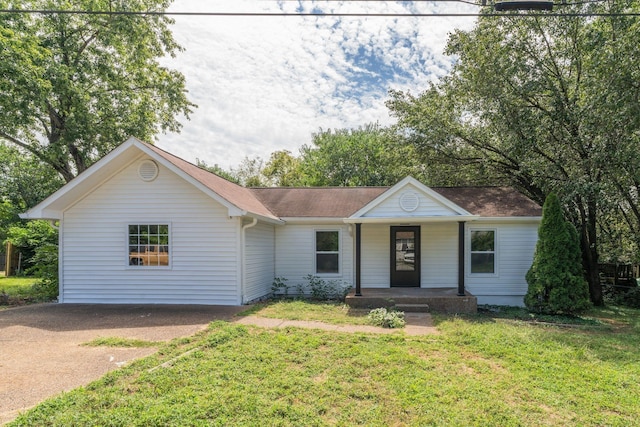 ranch-style house with a porch, a front lawn, roof with shingles, and driveway
