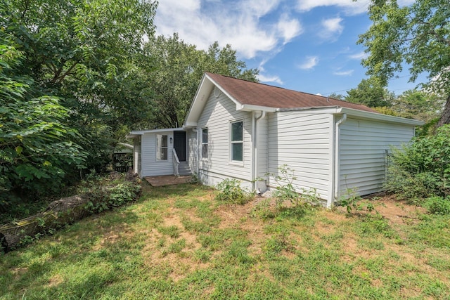 view of property exterior with a yard