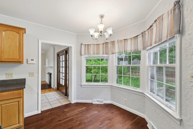 111 Lois Ln, Clarksville, TN 37043 - unfurnished dining area featuring a chandelier, plenty of natural light, dark wood-style flooring, and baseboards