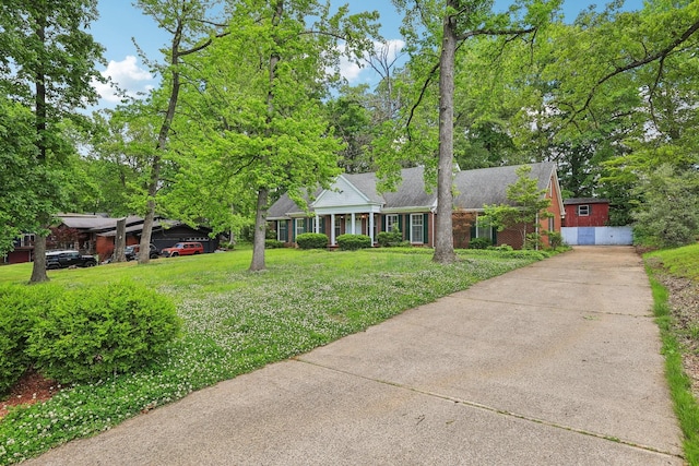 111 Lois Ln, Clarksville, TN 37043 - view of front facade with a front lawn, concrete driveway, brick siding, and roof with shingles