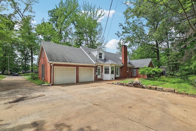 111 Lois Ln, Clarksville, TN 37043 - cape cod home with brick siding, an attached garage, a chimney, concrete driveway, and roof with shingles