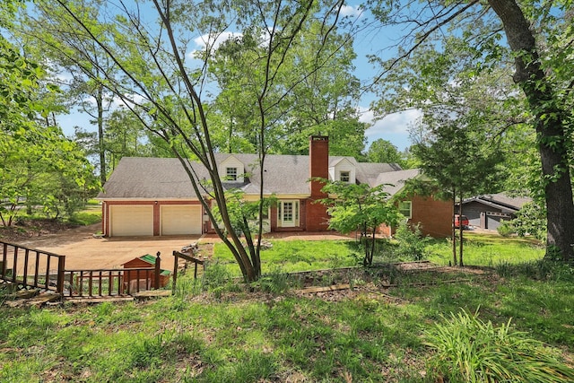 111 Lois Ln, Clarksville, TN 37043 - rear view of property with a chimney, driveway, a garage, and fence