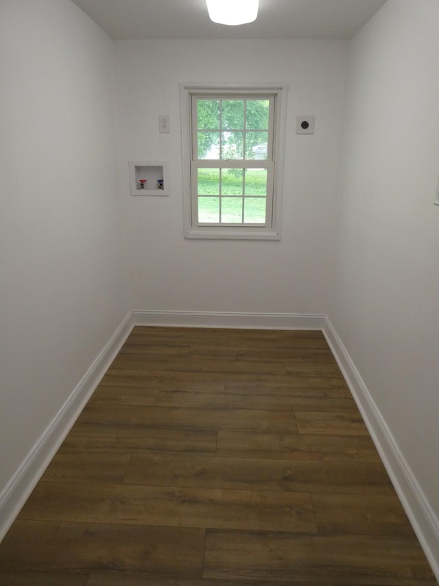 empty room featuring dark wood-style floors and baseboards
