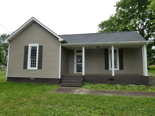 view of front facade with crawl space, covered porch, a front yard, and roof with shingles
