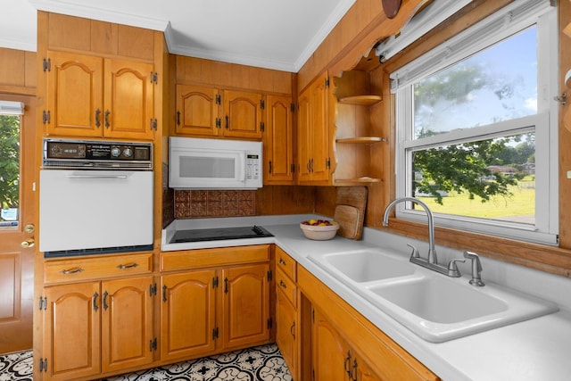 kitchen with white appliances, a sink, open shelves, light countertops, and brown cabinetry