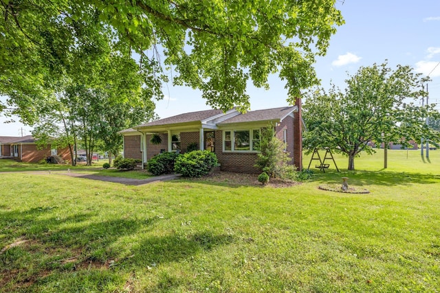 ranch-style home featuring a front yard and brick siding