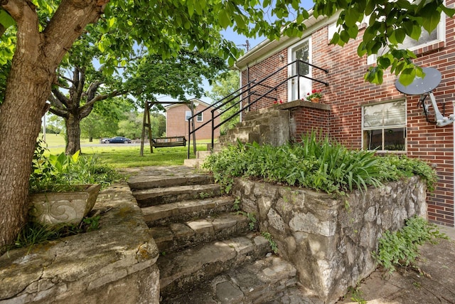 view of side of home featuring brick siding