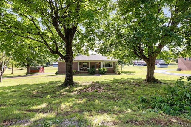 view of green lawn featuring covered porch