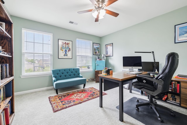 carpeted office with plenty of natural light, ceiling fan, and baseboards