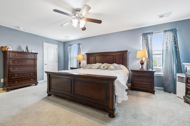 bedroom with light colored carpet, baseboards, and ceiling fan