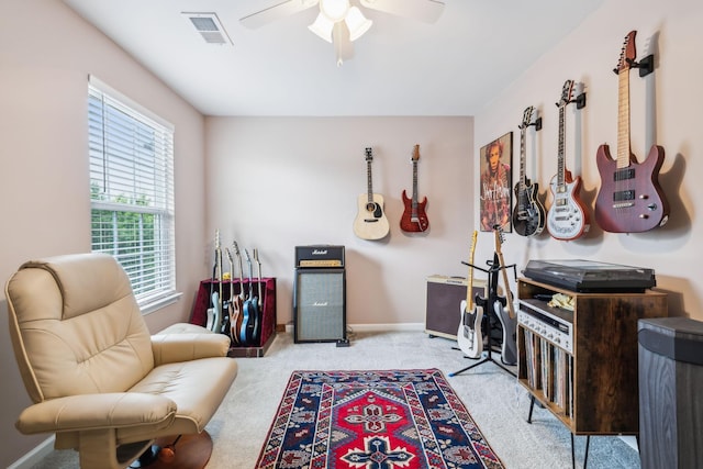 sitting room with carpet, a ceiling fan, and baseboards