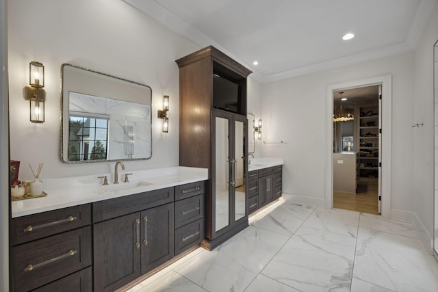 full bathroom featuring two vanities, a spacious closet, baseboards, recessed lighting, and marble finish floors