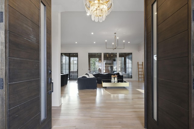 entryway featuring a chandelier, light wood finished floors, and recessed lighting