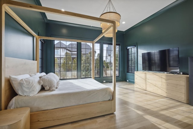 bedroom with wood finished floors and recessed lighting