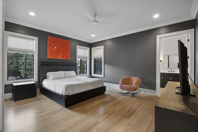 bedroom with light wood-style flooring, baseboards, recessed lighting, connected bathroom, and ornamental molding
