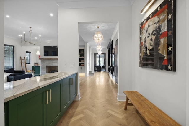 hallway featuring a chandelier, recessed lighting, baseboards, and crown molding